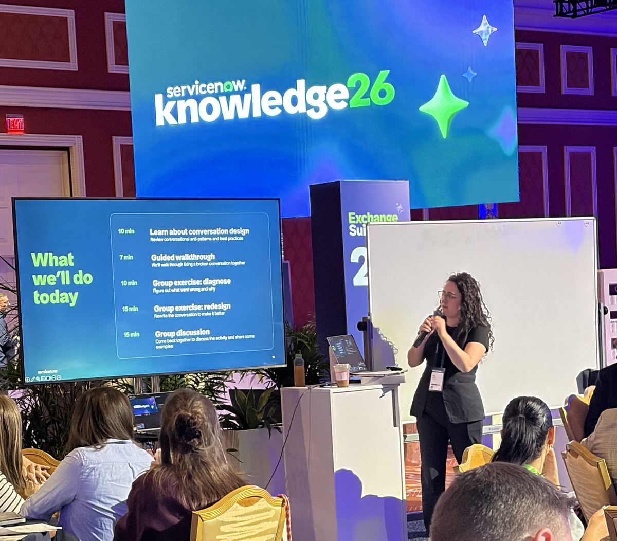Alea Abrams presenting a conversation design workshop to a full room at ServiceNow Knowledge 2026, with the session agenda on screen beside her.